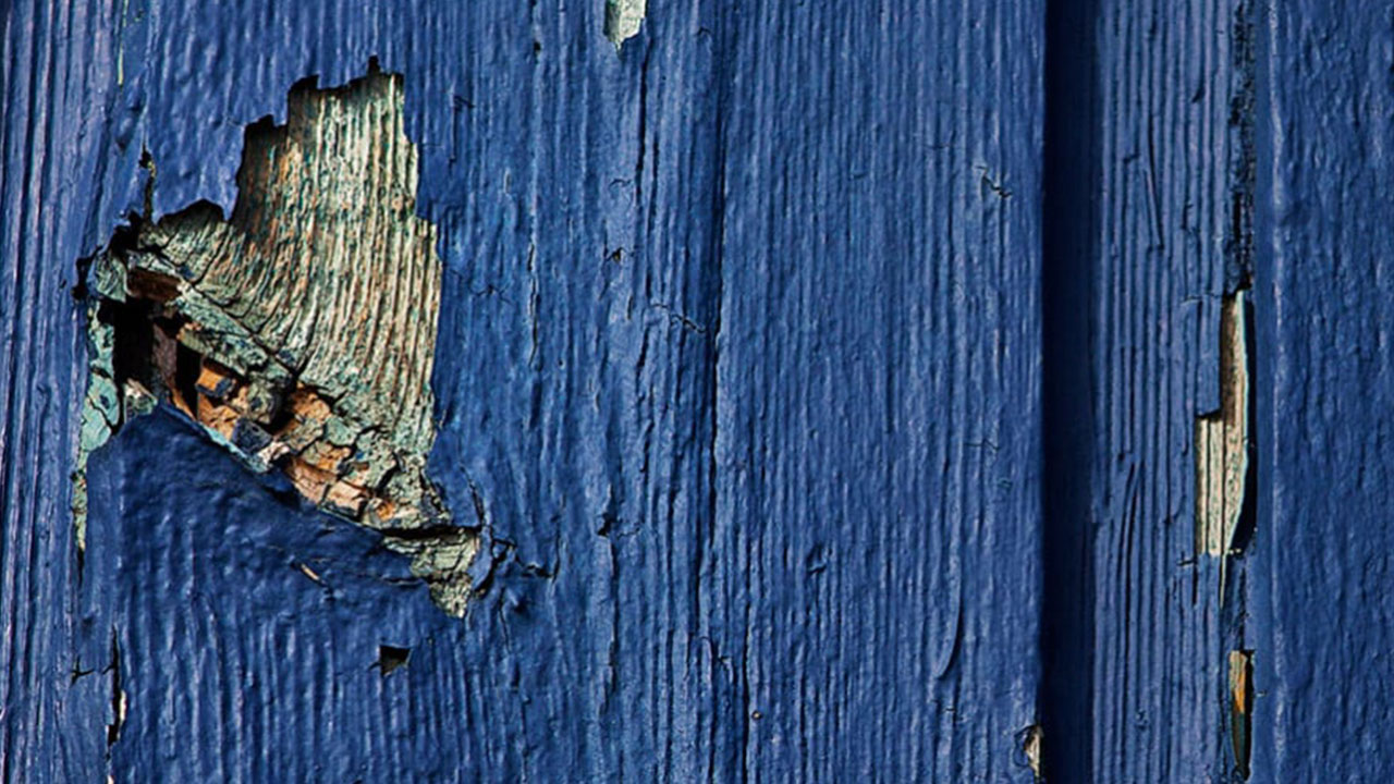 Close-up of cracked blue wood with peeling paint, used as the featured image for Linwood Bell’s heartfelt demo recording of “My Broken Hearts” using the Scarbee Rhodes.