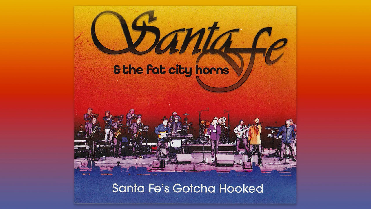 Santa Fe & The Fat City Horns perform live on stage with a vibrant red and orange sunset-style background and bold logo